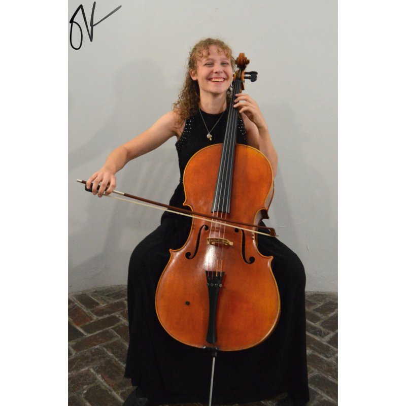 This image shows a profile shot of Julia Kostraba excitedly playing the cello